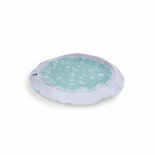 Little Ocean portable beach pool made from recycled fabric with a white border and mint green seashell pattern base.