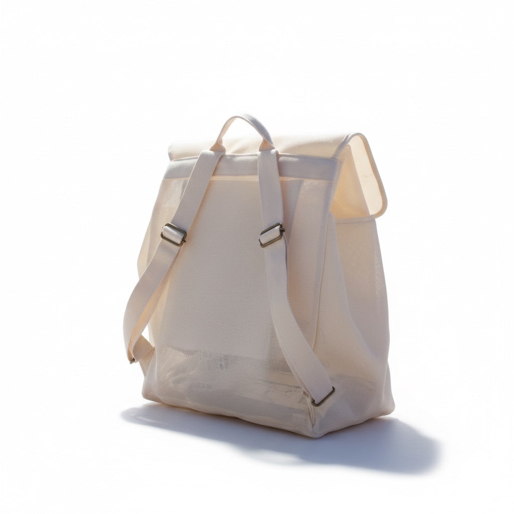 Little Ocean The Solo Traveller beach bag in cream mesh with adjustable cotton straps and brushed copper hardware.